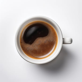 A cup of black coffee with froth on top, placed on a white surface photo