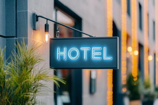 Hotel sign in a city street with blurred background. Urban atmosphere photo