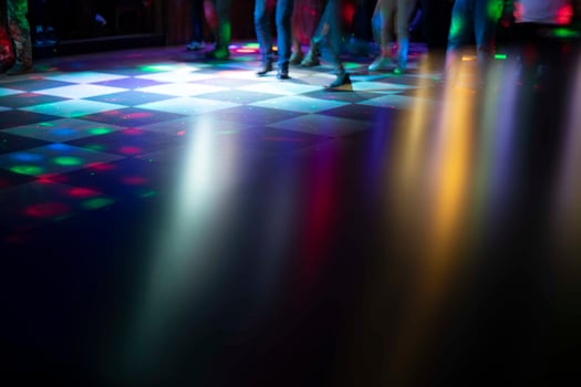 Disco in club. Dance floor in colored spots. Light music in club. photo
