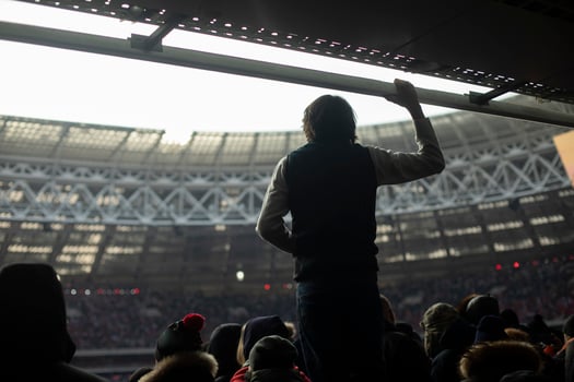 Guy at stadium. Silhouette of man against background of stadium. Mass event and one person. photo