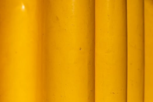 Yellow rubber material. Yellow curtain from moisture. Folds on material. photo