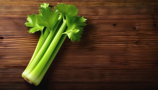 A fresh celery stalk on a wooden brown background photo