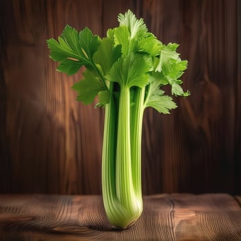A fresh celery stalk on a wooden brown background photo