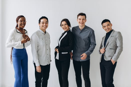 Cheerful multiracial professional business people laughing together standing in row near wall, happy diverse young employees students group, corporate staff team having fun, human resource concept photo