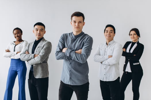 Cheerful multiracial professional business people laughing together standing in row near wall, happy diverse young employees students group, corporate staff team having fun, human resource concept photo