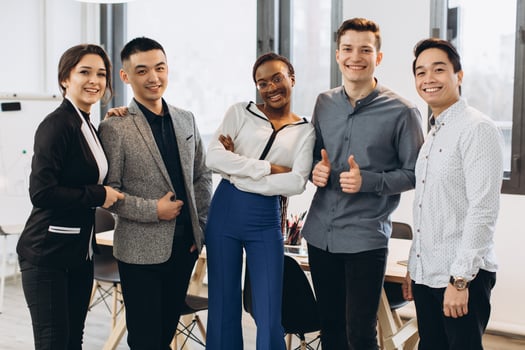Group of young businesspeople standing together in office photo