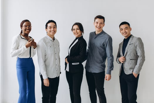 Cheerful multiracial professional business people laughing together standing in row near wall, happy diverse young employees students group, corporate staff team having fun, human resource concept photo
