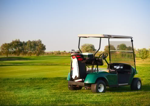 Golf car on the golf course photo