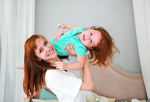 Young woman having fun with daughter photo