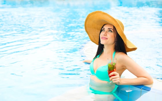 Real female beauty enjoying her summer vacation at swimming pool photo