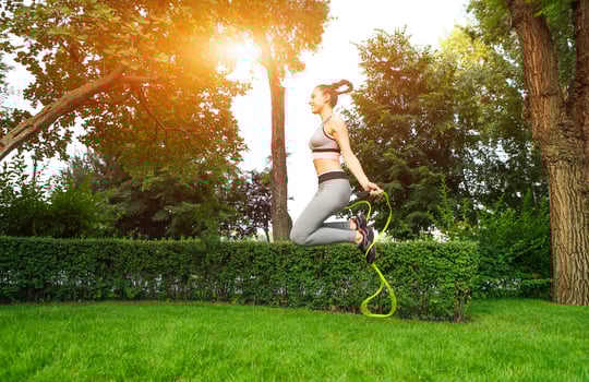 Young sporty woman with jumping rope photo