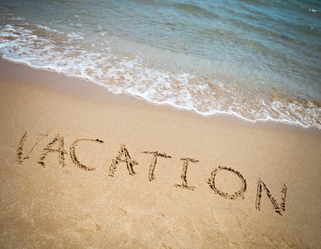 Vacation written in a sandy tropical beach photo