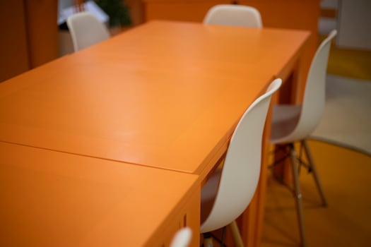 Orange table. Chairs at the table. Empty places. photo
