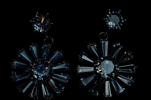 A pair of earrings with crystal flowers photo
