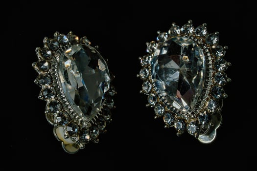Two large diamond earrings with a black background photo