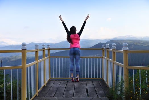 Young woman standing on viewing platform photo