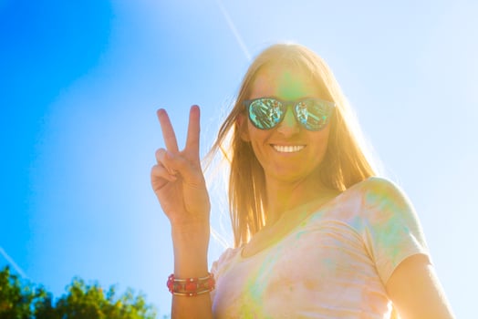 Happy young woman on holi color festival photo