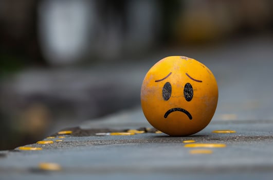 Yellow sad face ball expressing sadness photo