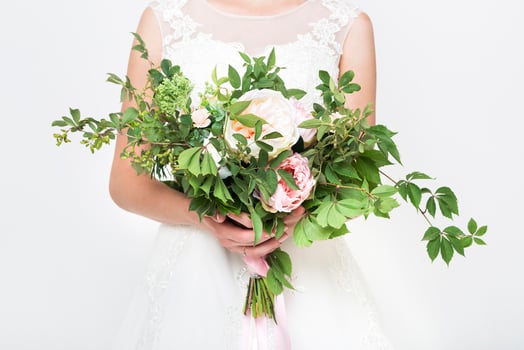 Young pretty bride with wedding bouquet photo