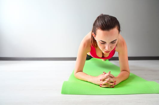 Young woman doing exercises on the floor photo