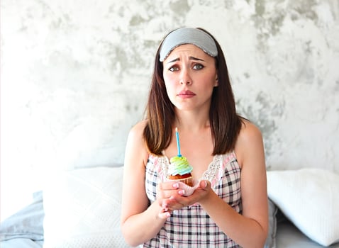 Sad lonely woman on her Birthday holding cupcake photo