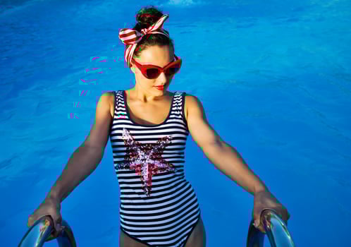 Beautiful pin up girl near the swimming pool photo