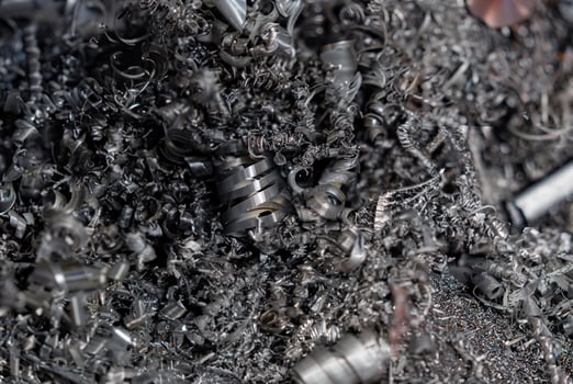 A detailed close-up of metal shavings and scrap from machining, showcasing intricate textures and industrial waste photo