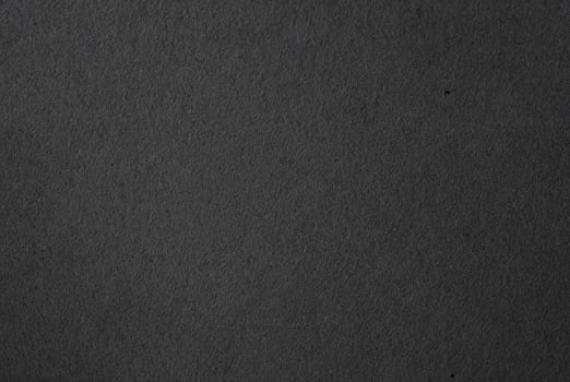 Close-up of dark textured black paper surface, ideal for backgrounds, textures, and minimalist design projects. photo