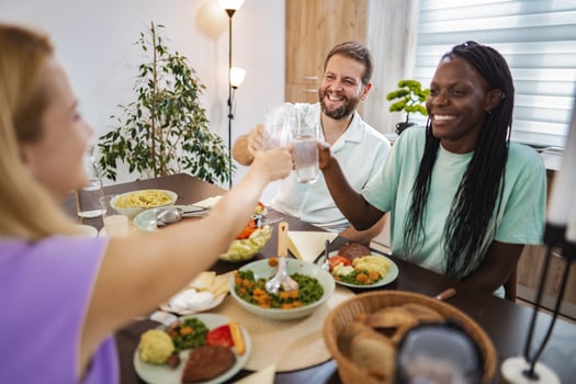Friends enjoying a joyful dinner in a cozy home setting photo