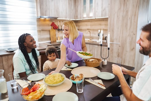 Family gathering enjoying a delicious meal together at home photo
