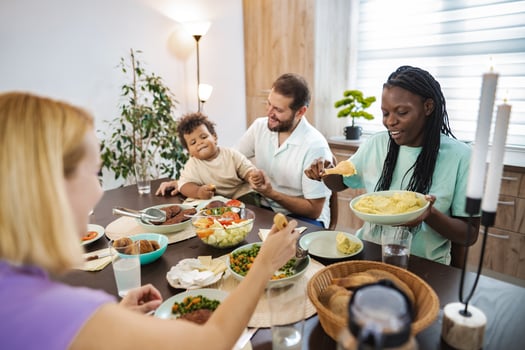 Family gathers joyfully for a home-cooked meal together photo