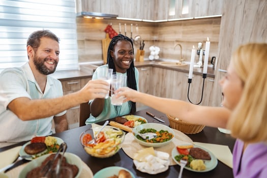 Friends dining happily in a cozy kitchen photo