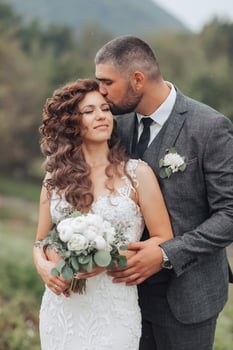 A bride and groom are kissing each other photo