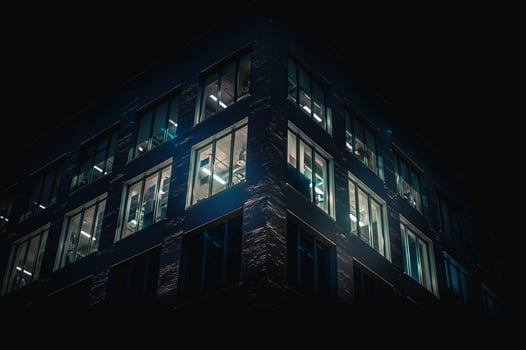 Office building at night where window glowing blue, Brighton, East Sussex, UK photo