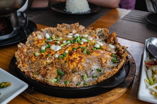 Close up Oyster omelette on the hot pan photo