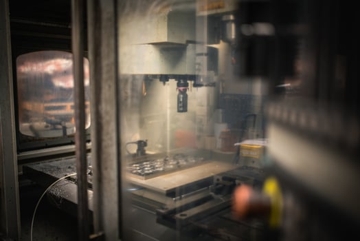 Industrial milling CNC machine behind dirty safety cover waiting for input photo