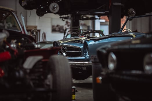 Classic cars being restored in a vintage vehicle garage workshop photo