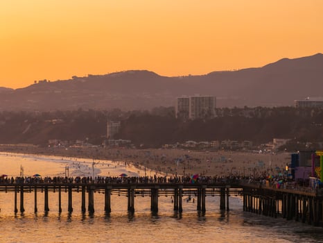 Sunset View of Santa Monica Pier with Ferris Wheel and Mountains photo