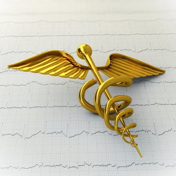 Golden Caduceus on Ecg - Ekg Paper - Medical Concept Illustration photo