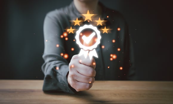 A person holding a glowing star with five stars photo