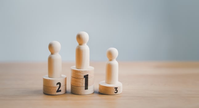 Three wooden figures standing on top of each other photo