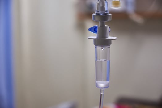 Close-up of slow iv fluid intravenous drip saline with blurred background in a hospital room, medical concept with copy space photo