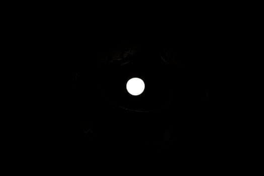 Light in dark. White circle in black. Bright lamp. photo
