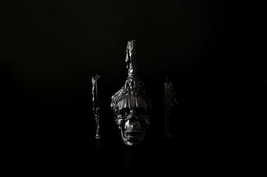 Halloween background with skull that have candle on it with another candles on black background. Minimal concept. photo