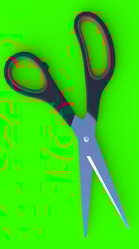 Scissors with green background photo