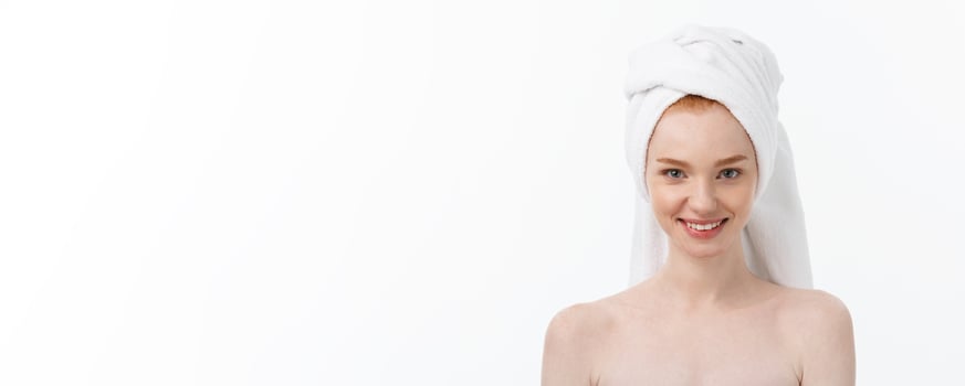 Surprised Beautiful Young Woman After Bath with A Towel On Her Head Isolated On white Background. Skin Care And Spa Theme. photo