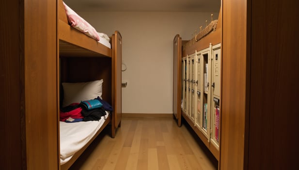 Cozy hostel dormitory scene featuring bunkbeds lockers and warm lighting embodying budget travel and camaraderie photo