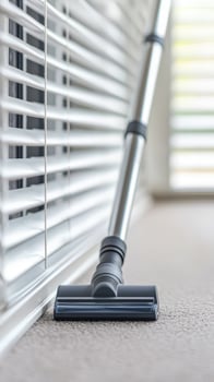 Vacuum cleaner on carpet near blinds, white isolate background photo