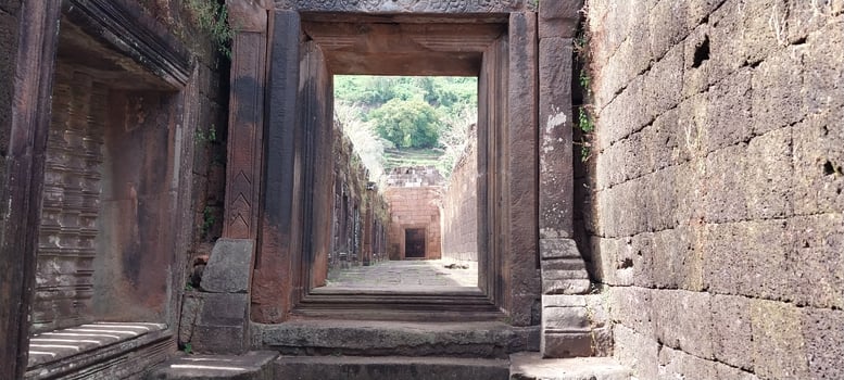 Ancient stone architecture featuring a series of doorways creating a captivating pathway, showcasing historical craftsmanship and scenic beauty. photo