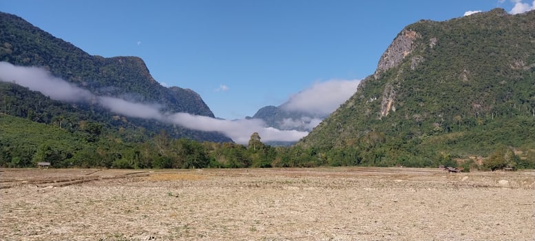 Scenic view of a lush mountain valley with clouds and blue sky, perfect for nature and travel themes. photo